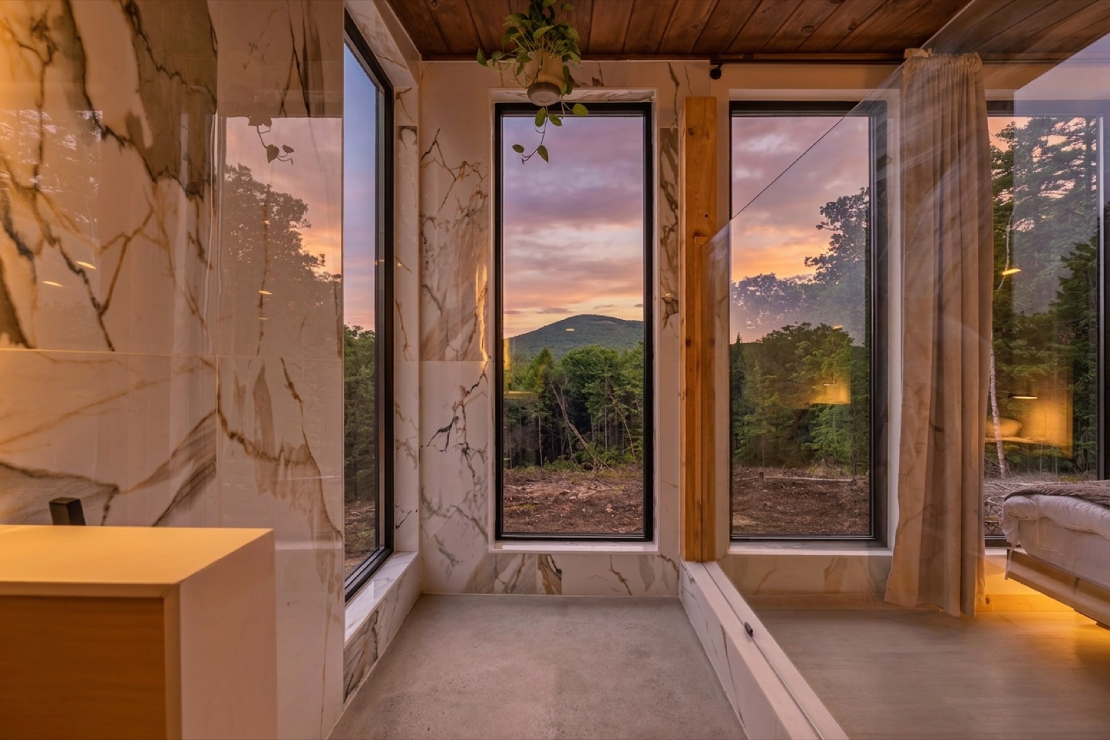 Marble tile spa shower with a window to the hills
